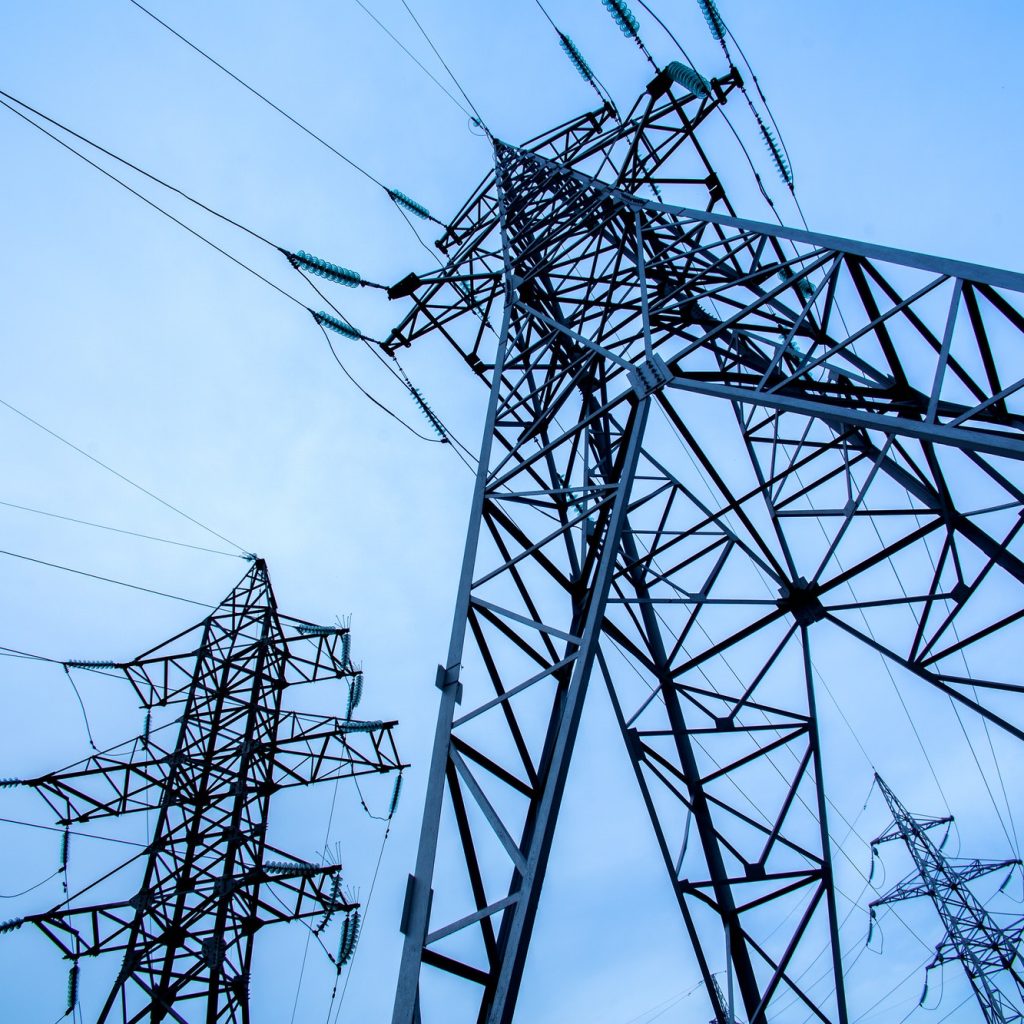 Electricity pylons on blue sky background. Power and energy. Energy conservation